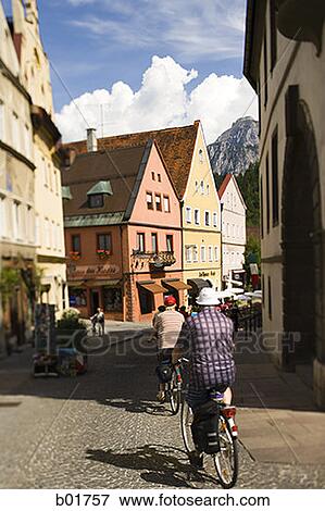 Rear view of two men riding a bicycle View Large Photo Image Stock Photo - Rear view of two men riding a bicycle. Fotosearch
