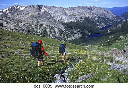 Rear view of two people hiking View Large Photo Image Stock Photography - Rear view of two people hiking. Fotosearch