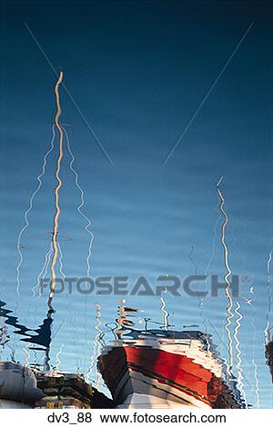 Stock Photo - Reflection of a sailboat on water. Fotosearch