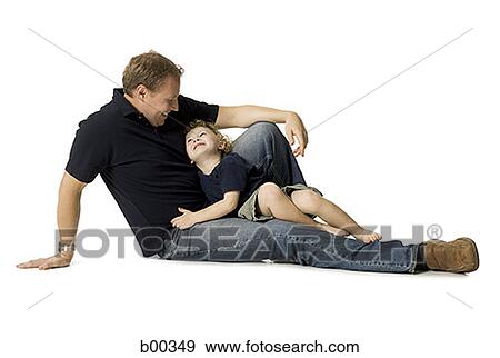 Side profile of a father with his son sitting on his lap View Large Photo Image Stock Photo - Side profile of a father with his son sitting on his lap. Fotosearch