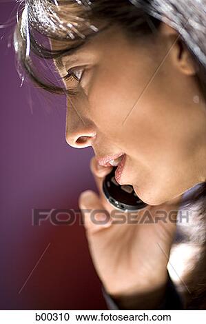 Side profile of a mid adult woman talking on a mobile phone View Large Photo Image Stock Image - Side profile of a mid adult woman talking on a mobile phone. Fotosearch