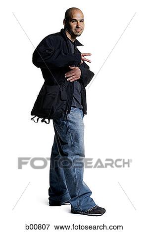 Side profile of a young man carrying a bag View Large Photo Image Stock Photo - Side profile of a young man carrying a bag. Fotosearch