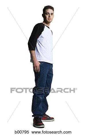 Stock Photography - Side profile of a young man standing with his hand in his pocket. Fotosearch