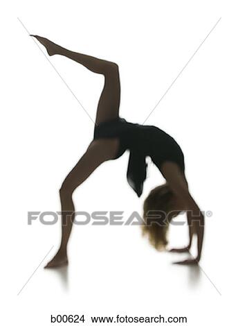 Side profile of a young woman bending over backwards View Large Photo Image Picture - Side profile of a young woman bending over backwards. Fotosearch