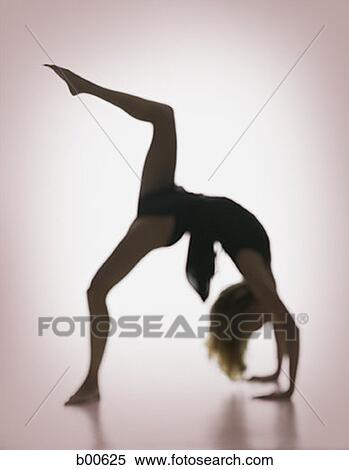 Stock Photography - Side profile of a young woman bending over backwards. Fotosearch