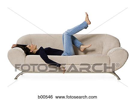 Side profile of a young woman lying on a couch View Large Photo Image Stock Photograph - Side profile of a young woman lying on a couch. Fotosearch