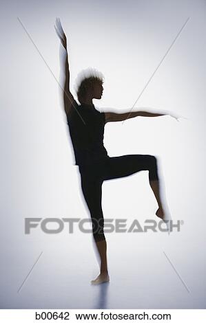Silhouette of a young man standing on one leg View Large Photo Image Stock Image - Silhouette of a young man standing on one leg. Fotosearch