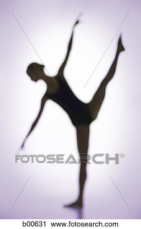 Stock Image - Silhouette of a young woman standing on one leg. Fotosearch