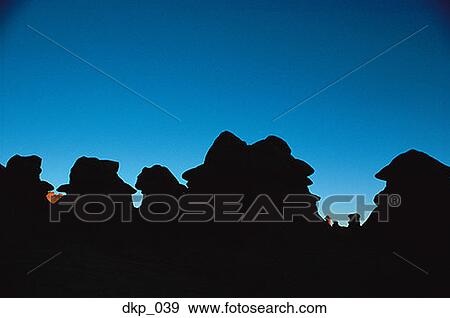 Silhouette of rock formations in a desert View Large Photo Image Stock Photo - Silhouette of rock formations in a desert. Fotosearch
