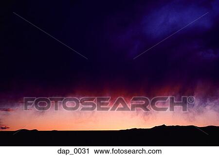 Stock Image - Storm clouds over a landscape. Fotosearch