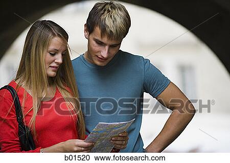 Teenage couple looking at a map View Large Photo Image Stock Image - Teenage couple looking at a map. Fotosearch