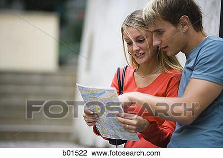 Teenage couple looking at a map View Large Photo Image Stock Image - Teenage couple looking at a map. Fotosearch