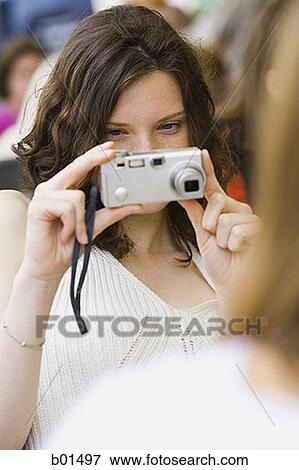 Teenage girl holding a digital camera View Large Photo Image Stock Photo - Teenage girl holding a digital camera. Fotosearch
