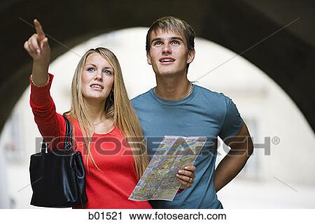 Teenage girl holding a map and pointing View Large Photo Image Stock Image - Teenage girl holding a map and pointing. Fotosearch