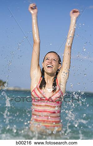 Teenage girl splashing water in the ocean View Large Photo Image Stock Photograph - Teenage girl splashing water in the ocean. Fotosearch