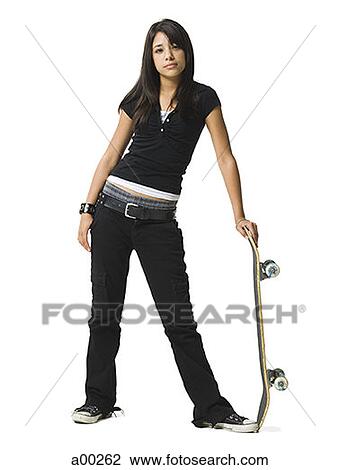Teenage girl standing and holding a skateboard View Large Photo Image Stock Image - Teenage girl standing and holding a skateboard. Fotosearch
