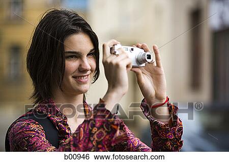 Teenage girl taking a photograph View Large Photo Image Stock Photograph - Teenage girl taking a photograph. Fotosearch