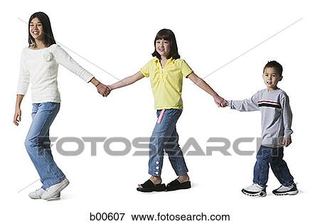 Three children holding hands and walking View Large Photo Image Stock Photo - Three children holding hands and walking. Fotosearch
