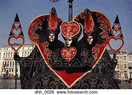 Stock Photograph - Three people dressed in masquerade costumes. Fotosearch