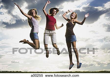 Three women jumping View Large Photo Image Stock Photography - Three women jumping . Fotosearch