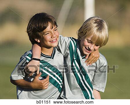 Two boys in soccer uniforms, with arms around each other View Large Photo Image Stock Image - Two boys in soccer uniforms, with arms around each other. Fotosearch