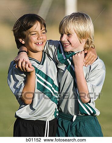 Two boys in soccer uniforms, with arms around each other View Large Photo Image Stock Image - Two boys in soccer uniforms, with arms around each other. Fotosearch