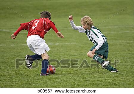 Stock Photo - Two boys playing soccer. Fotosearch