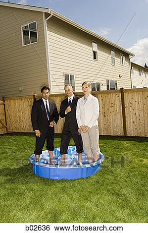 Two businessmen and a businesswoman standing in a wading pool View Large Photo Image Stock Photograph - Two businessmen and a businesswoman standing in a wading pool. Fotosearch
