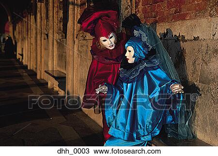 Stock Image - Two people dressed in masquerade costumes. Fotosearch