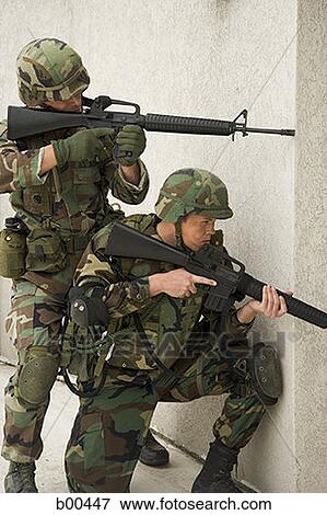 Two soldiers aiming their rifles View Large Photo Image Stock Photo - Two soldiers aiming their rifles. Fotosearch