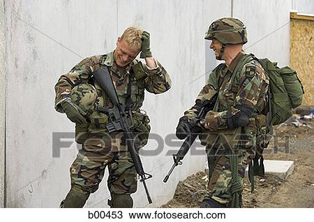 Two soldiers talking to each other View Large Photo Image Stock Image - Two soldiers talking to each other. Fotosearch