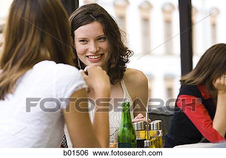 Two teenage girls sitting in a restaurant View Large Photo Image Stock Photograph - Two teenage girls sitting in a restaurant. Fotosearch