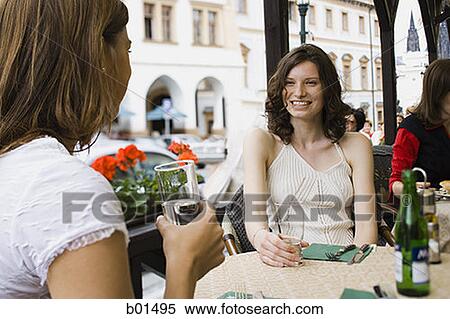 Two teenage girls sitting in a restaurant View Large Photo Image Stock Photography - Two teenage girls sitting in a restaurant. Fotosearch