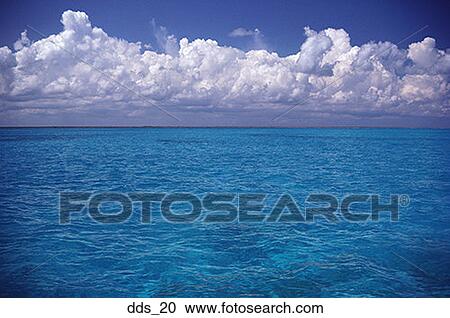 View of a blue sea with clouds overhead View Large Photo Image Stock Image - View of a blue sea with clouds overhead. Fotosearch