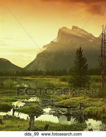 View of a mountain that overlooks a lake View Large Photo Image Stock Photo - View of a mountain that overlooks a lake. Fotosearch