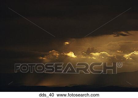 View of sunlight through dark clouds View Large Photo Image Stock Image - View of sunlight through dark clouds. Fotosearch