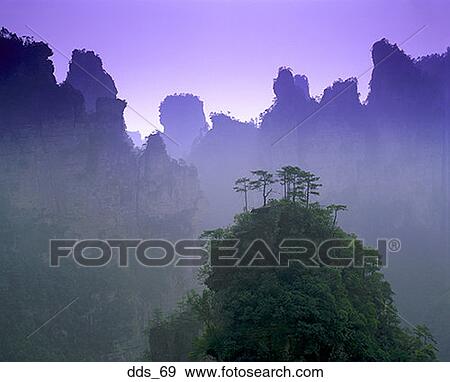 Stock Photo - View of unique tree-covered mountain tops. Fotosearch