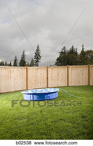 Wading pool with hose on a lawn View Large Photo Image Stock Photo - Wading pool with hose on a lawn. Fotosearch