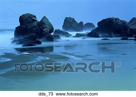 Waves breaking on rocks at a beach View Large Photo Image Stock Image - Waves breaking on rocks at a beach. Fotosearch