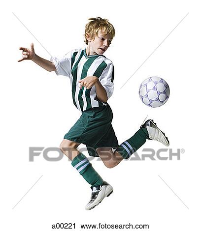 Young boy kicking a soccer ball View Large Photo Image Stock Image - Young boy kicking a soccer ball. Fotosearch