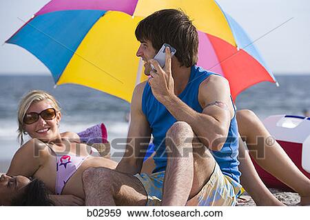 Young couple at the beach View Large Photo Image Stock Photo - Young couple at the beach. Fotosearch