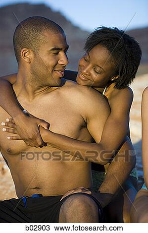 Young couple hugging outdoors View Large Photo Image Stock Image - Young couple hugging outdoors. Fotosearch