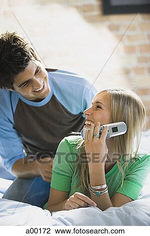 Stock Image - Young couple in a bed together. Fotosearch
