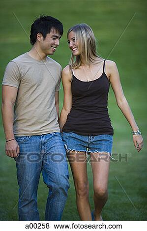 Young couple walking holding hands View Large Photo Image Stock Photo - Young couple walking holding hands. Fotosearch