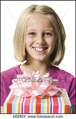 Young girl holding a gift View Large Photo Image Picture - Young girl holding a gift. Fotosearch