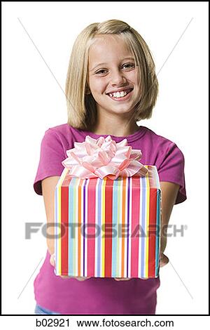 Stock Image - Young girl holding a gift. Fotosearch