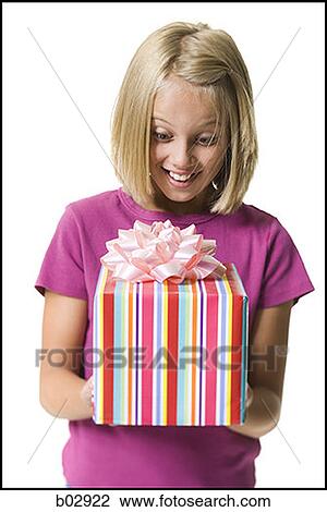 Young girl holding a gift View Large Photo Image Stock Image - Young girl holding a gift. Fotosearch