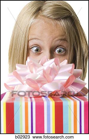 Young girl holding a gift View Large Photo Image Stock Image - Young girl holding a gift. Fotosearch