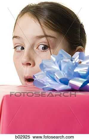 Young girl holding a gift View Large Photo Image Stock Photography - Young girl holding a gift. Fotosearch