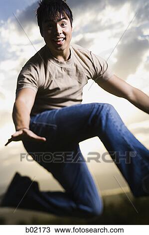 Young man jumping and smiling View Large Photo Image Stock Image - Young man jumping and smiling. Fotosearch